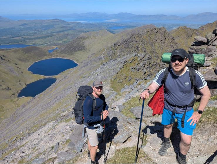Cocleshell music dus climbing to the summit of Carrauntoohil on a sunny day