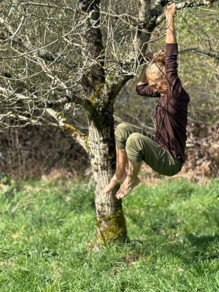 woman dances gracefully with tree